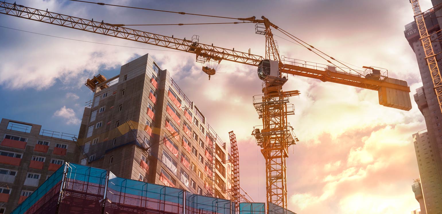 A construction crane working amid tall buildings